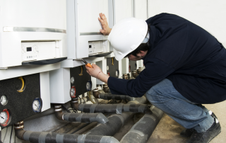 man inspecting a machine